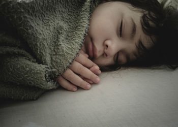 Portrait of cute baby sleeping on bed