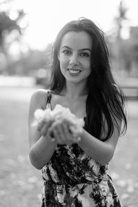 Portrait of smiling young woman standing outdoors