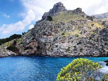 Scenic view of rocks in sea against sky