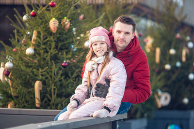 Portrait of smiling father with daughter during christmas