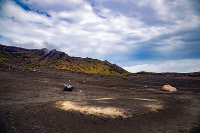 View on a black soil and rocks in the volcanic landscape near to aso mountain in kyushu, japan