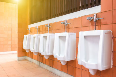 Row of objects on wall in bathroom