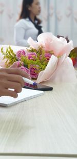 Midsection of woman holding flower bouquet