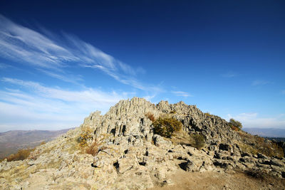 Low angle view of rocks against sky