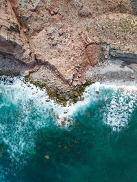 High angle view of rock formation in sea