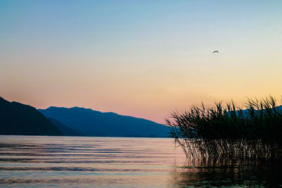 Scenic view of lake at sunset