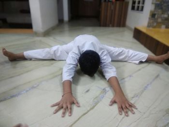 High angle view of man lying on floor at home