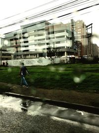 Man walking on road in city