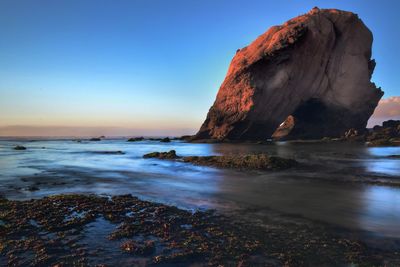 Scenic view of rock formation by sea