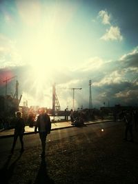 Silhouette of people on city street during sunset