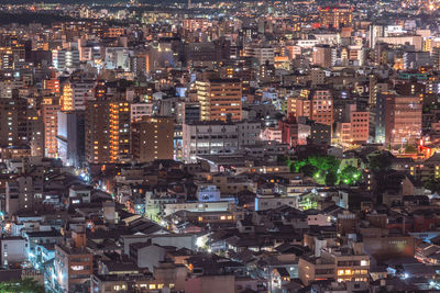 High angle view of illuminated buildings in city