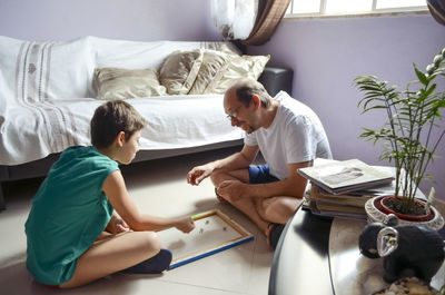 Father and child son playing glazing balls at home. happy home concept. salvador, bahia, brazil.