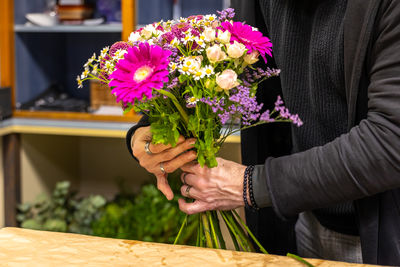Midsection of woman holding bouquet