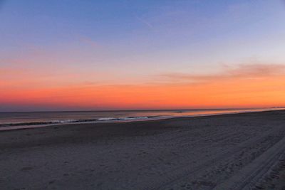 Scenic view of beach against sky during sunset