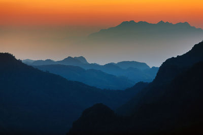 Scenic view of silhouette mountains against sky during sunset