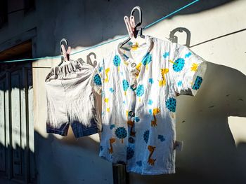 Clothes drying against white wall