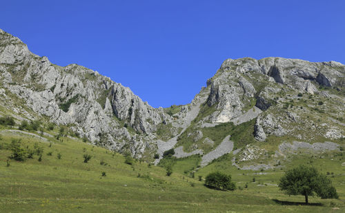 Scenic view of mountains against clear blue sky