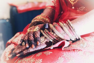 Midsection of bride wearing sari and personal accessories