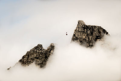 High angle view of cliff amidst clouds