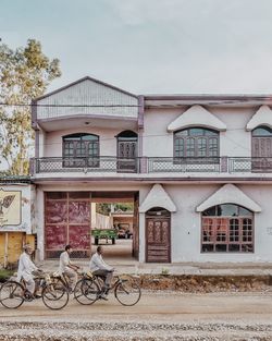 Bicycle by building against sky