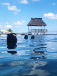 Swimming in sea against sky