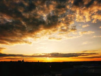 Silhouette of landscape against dramatic sky