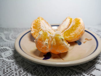 Close-up of orange slices in plate on table