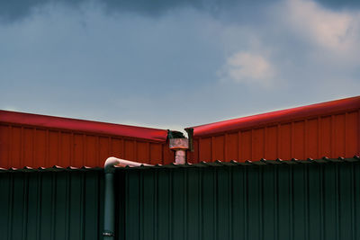 Low angle view of red building against sky