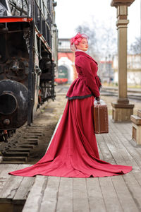 Portrait of young woman standing in train