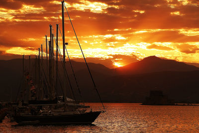 Sailboat sailing on sea against sky during sunset