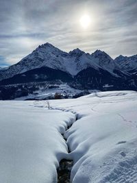 Snow covered mountains against sky