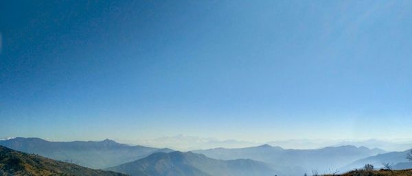 Scenic view of mountains against clear blue sky