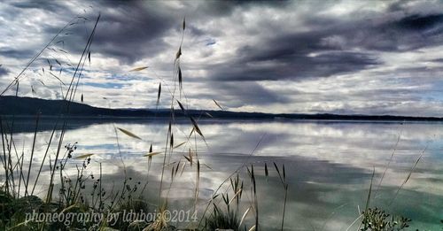 Scenic view of lake against cloudy sky