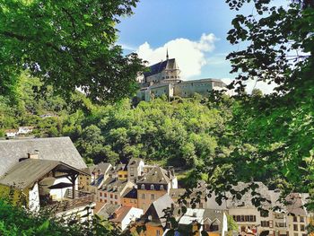 Buildings in town against sky