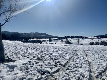 Scenic view of snow covered mountains against sky