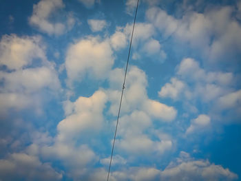 Low angle view of cables against blue sky