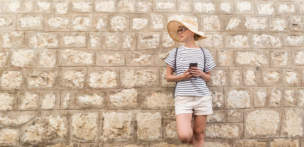 Full length of child standing against wall