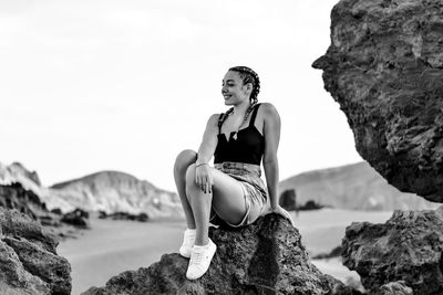 Woman sitting on rock