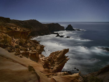 Scenic view of sea against sky at night