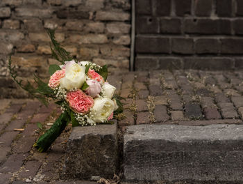 Close-up of rose bouquet on footpath