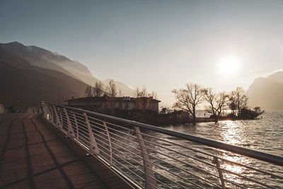 Scenic view of lake by mountains against sky