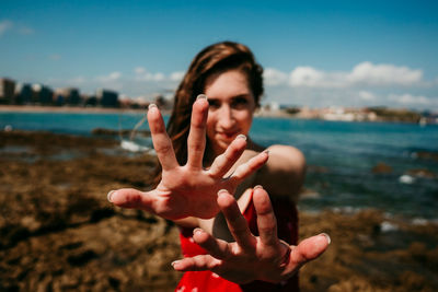 Portrait of woman hand on beach