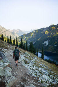 Rear view of man walking on mountain