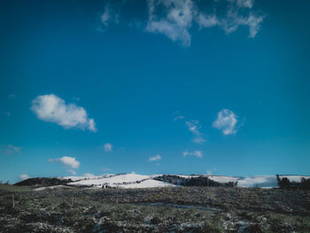 Scenic view of landscape against blue sky