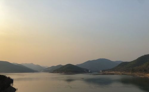 Scenic view of lake against clear sky during sunset