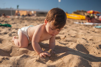 Boy playing on sand at beach