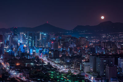 High angle view of illuminated city buildings at night