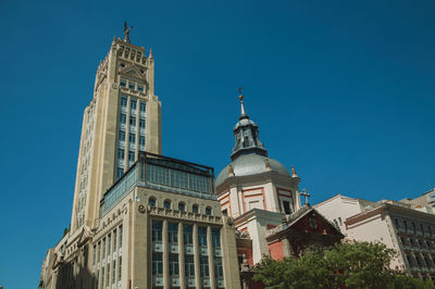 Low angle view of building against clear blue sky