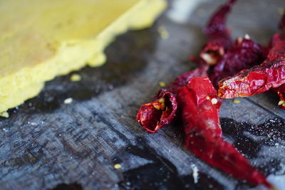 High angle view of red chili peppers on wood