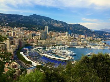 High angle view of city by sea against sky